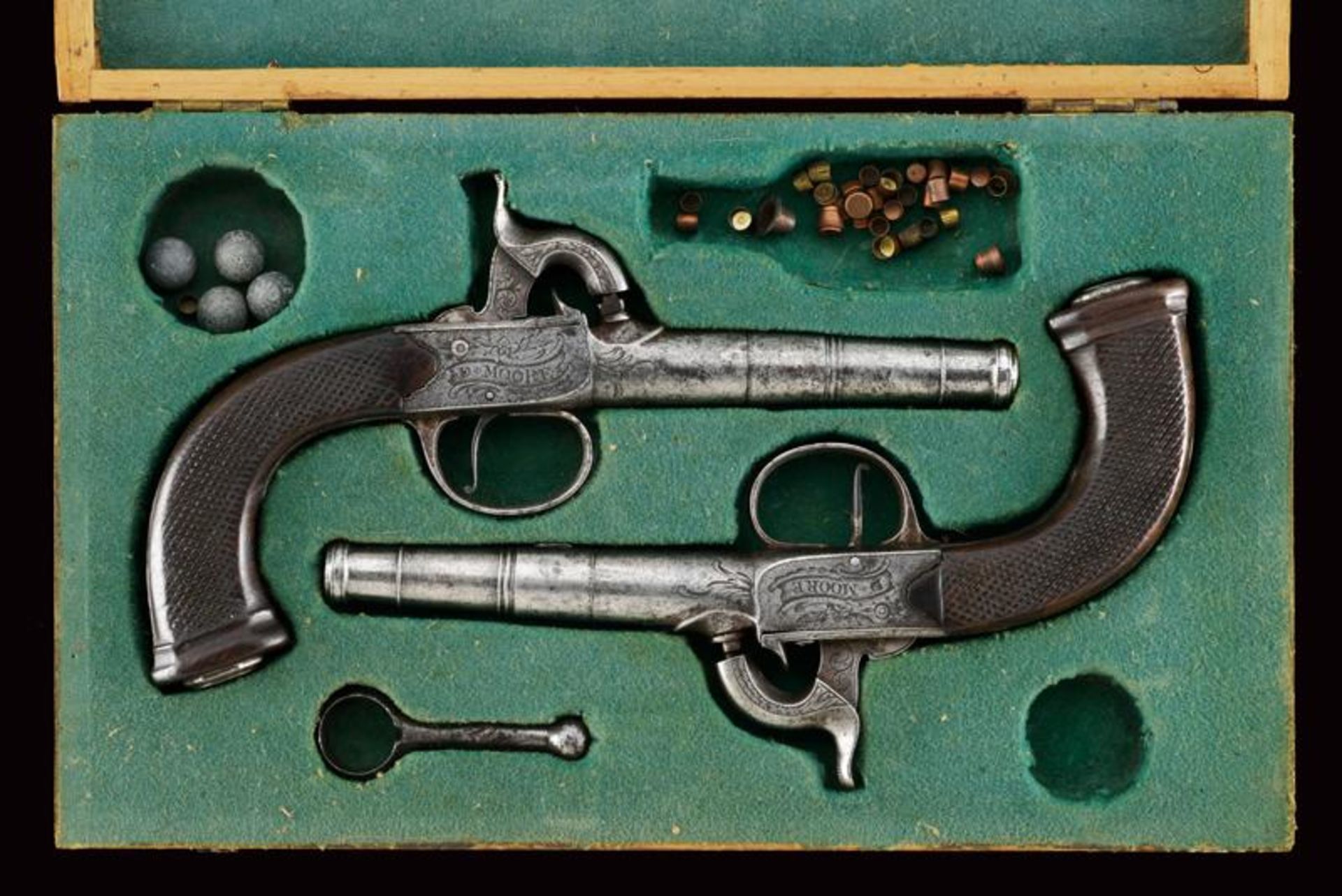 A pair of cased percussion pistols by D. Moore