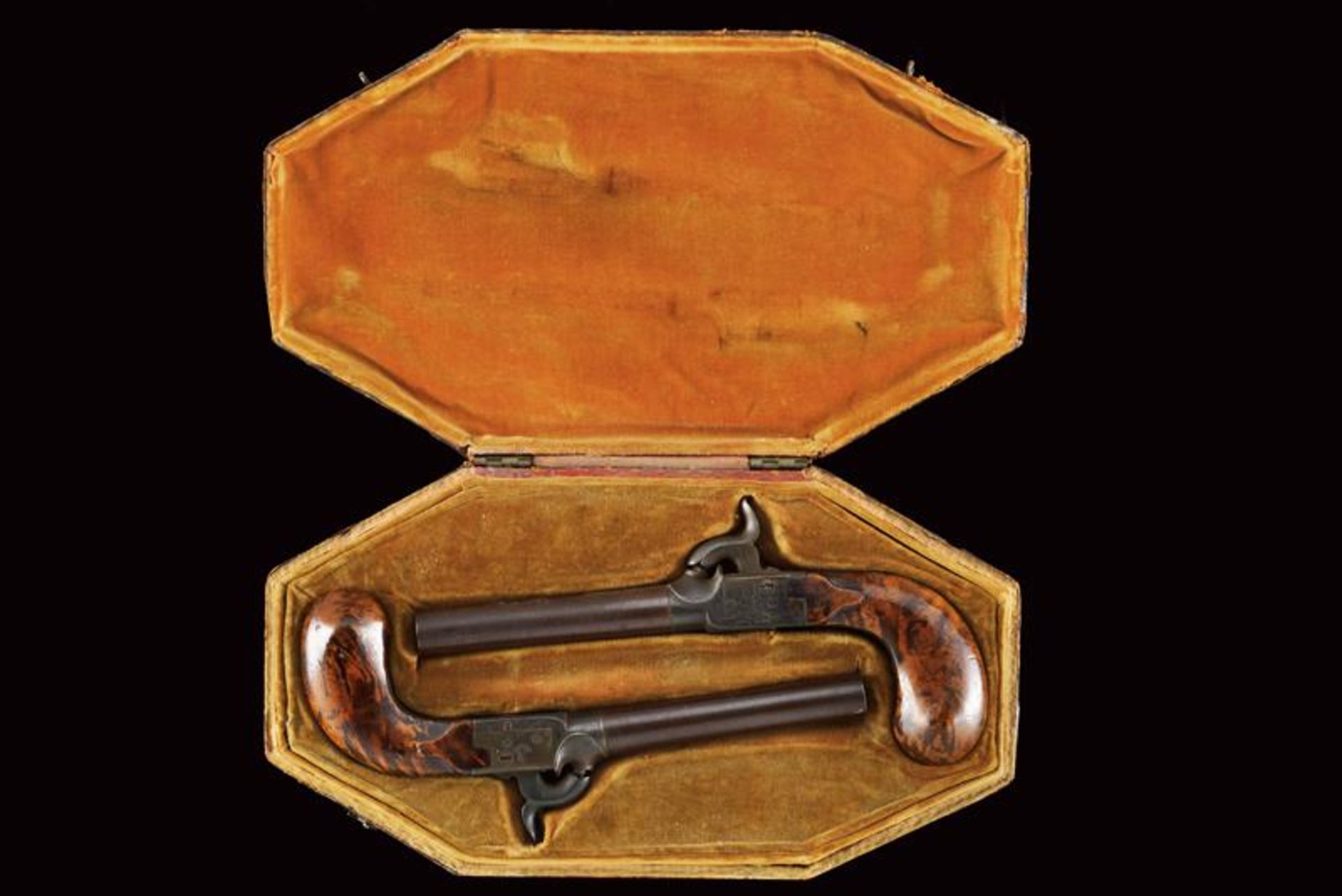 A pair of percussion pockets pistols in an elegant leather case