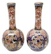 Pair of late 19th century Japanese Imari porcelain bottle vases with covers