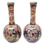 Pair of late 19th century Japanese Imari porcelain bottle vases with covers