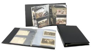 Three modern loose leaf albums containing over two-hundred and thirty war and military related postc