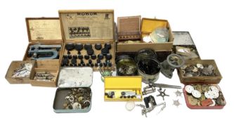 A selection of dismantled watch parts and tools