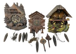 Three 20th century cuckoo clocks and weights for parts or repair.