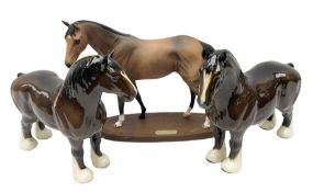 Royal Doulton �Troy� racehorse figure on wooden plinth and two Beswick bay Shire horses