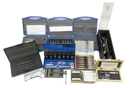 Collection of various clock repair tools and accessories