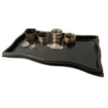 Four hallmarked silver napkin rings (total weight 83g) ebonised tray with hallmarked silver plaque w