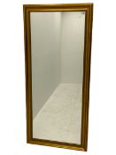 Large rectangular mirror in swept gilt frame decorated with foliate slip