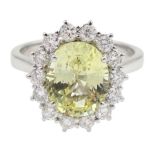 18ct white gold oval yellow sapphire and round brilliant cut diamond cluster ring