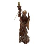 Carved hardwood table lamp modelled as a figure of an immortal