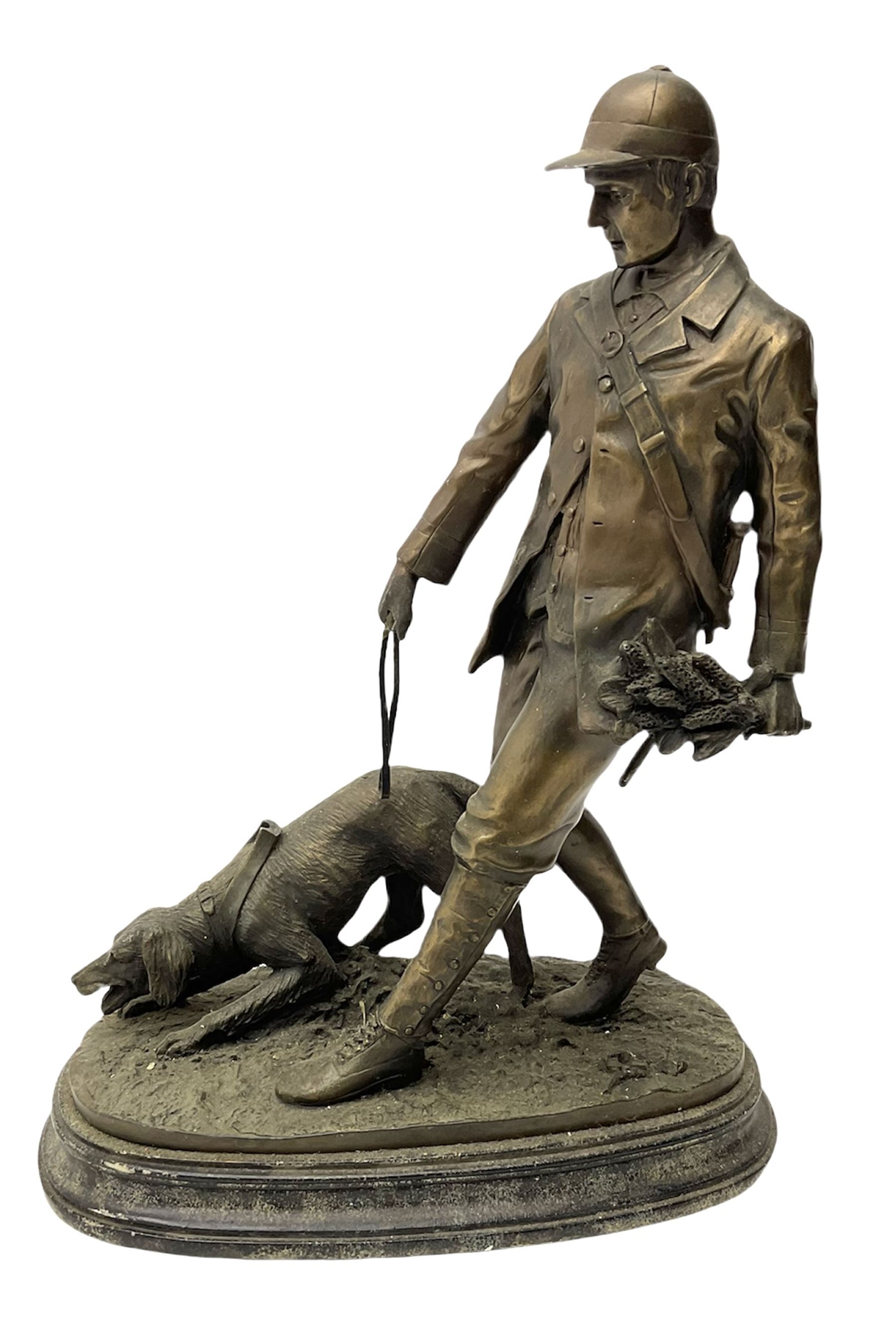 Bronzed figure of a huntsman with hound signed Tupton