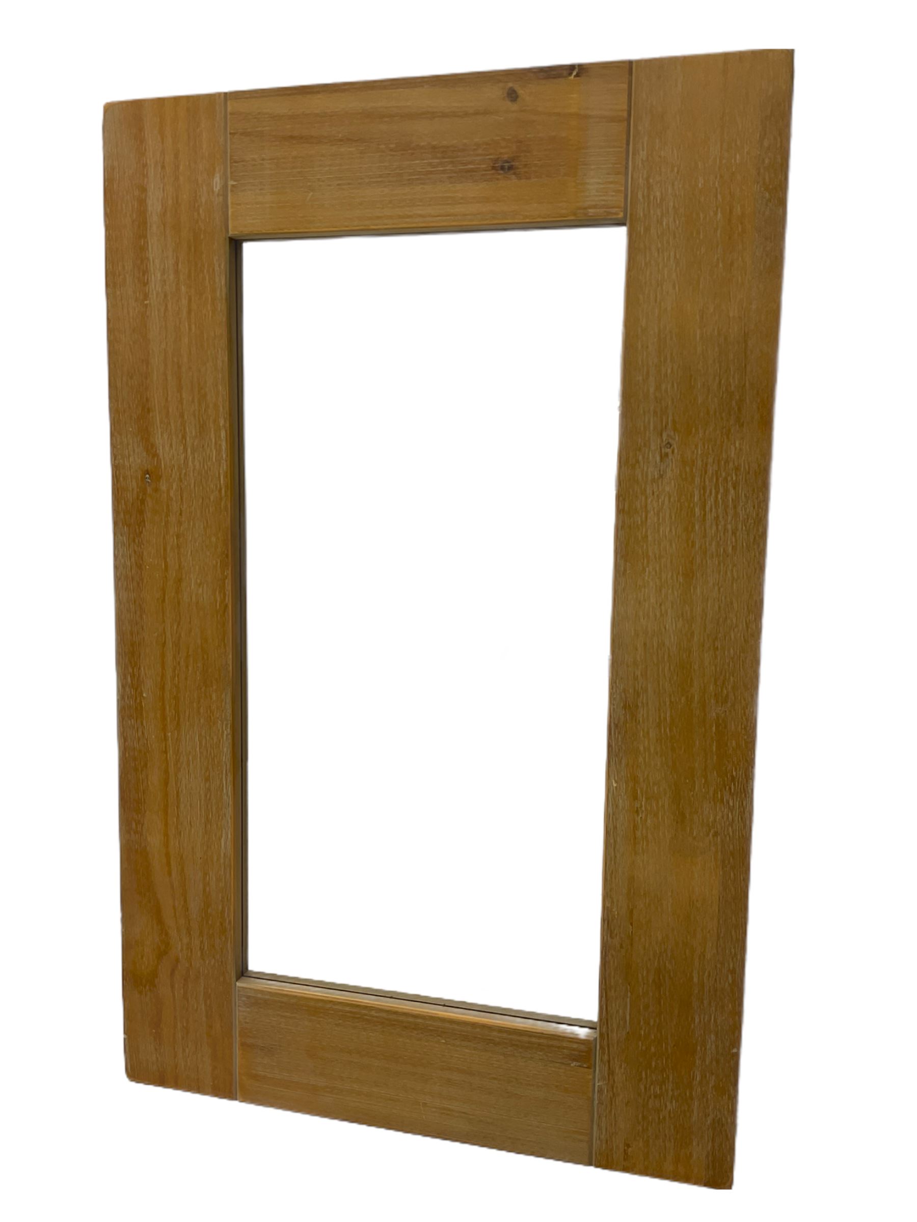 Light wood framed rectangular wall mirror