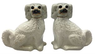 Pair of Victorian Staffordshire white glazed spaniels with glass eyes