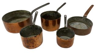 Five assorted graduated copper pans