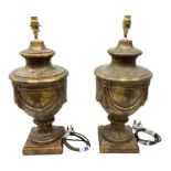 Pair of metal classical urn table lamps on a plinth base