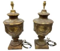 Pair of metal classical urn table lamps on a plinth base