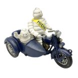 Cast iron figure of Michelin Man on motorbike modelled with smaller seated Michelin man in side car
