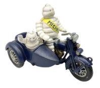 Cast iron figure of Michelin Man on motorbike modelled with smaller seated Michelin man in side car