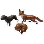 Three Beswick figures modelled as a fox in recumbent pose no.1017