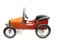 Red child's tin-plate pedal car with chrome detail