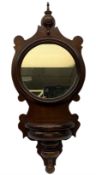 Mahogany wall bracket with circular mirror plate set against a shaped mahogany back with turned deta