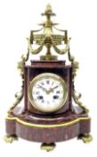 Late 19th century French Royal rouge marble and ormalu mantle clock of shaped bow front form