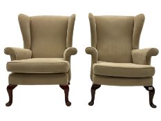 A pair of Parker Knoll wing back armchairs