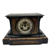 A French eight day striking mantle clock in a Belgium slate case with panels of contrasting variegat