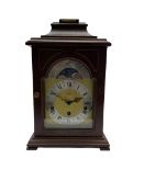 A 20th century Bracket clock in mahogany effect case with bell top pediment and glazed break arch d
