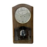 A mid 20th century German wall clock in a veneered mahogany case with a German eight day “Kienzle” m