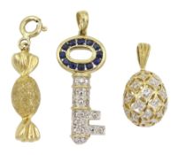 Three 9ct gold charms including sapphire and diamond key