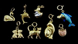 14ct gold duck charm and seven 9ct gold charms including two dolphins