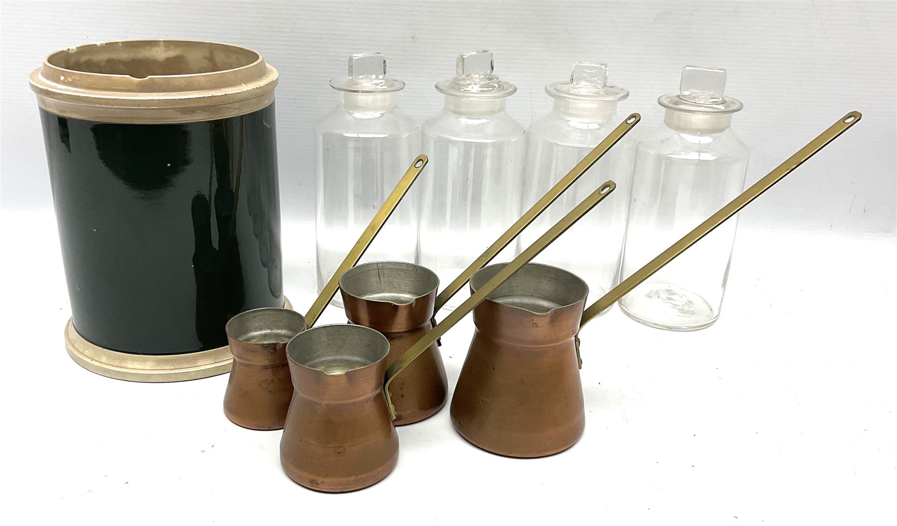 Set of four graduating copper ladles