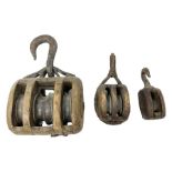 Three wooden hook pulley blocks