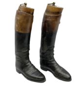 Pair of vintage gentleman's black leather calf length riding boots with brown leather banding and wo