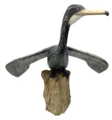 Wooden sculpture of Cormorant aquatic bird on a naturalistic wooden plinth