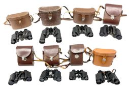 Eight cased pairs of binoculars