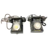 Two black bakelite rotary telephones