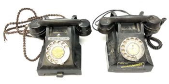 Two black bakelite rotary telephones