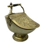 Victorian brass helmet shaped coal scuttle with embossed decoration and turned wooden handle and sho