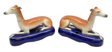 Pair of Staffordshire recumbent greyhound pen holders