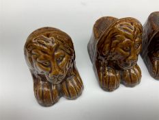 Set of four 19th century treacle glaze furniture/sash window rests modelled as lions