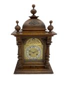 A German oak cased striking mantle clock manufactured by Junghans