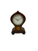 A small onion topped Edwardian boudoir clock in a waisted mahogany case with satinwood stringing to