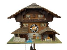 An automaton musical cuckoo clock with a 20th century three weight movement in the form of a Swiss C