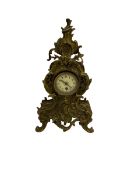 A tall gilt metal mantle clock in a rococo style case c1900