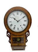 An American late 19th century oak and mahogany drop dial wall clock by Chauncey Jerome & Sons