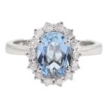 18ct white gold oval aquamarine and round brilliant cut diamond cluster ring