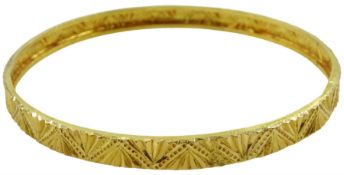 Middle Eastern 21ct gold bangle with engraved decoration