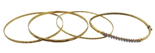 Gold diamond chip bangle and three other gold bangles with engraved decoration