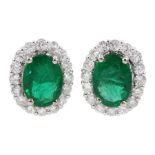 Pair of 18ct white gold oval emerald and round brilliant cut diamond cluster stud earrings